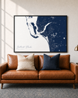 Southwest Florida canvas map — two-pillow black-frame sofa interior