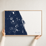 Space Coast canvas map — hands holding the canvas in an oak frame