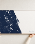 Space Coast canvas map — hands holding the canvas in an oak frame