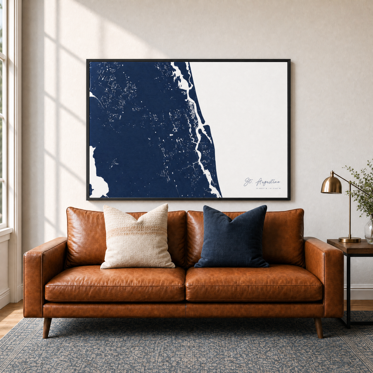 St. Augustine canvas map — two-pillow black-frame sofa interior