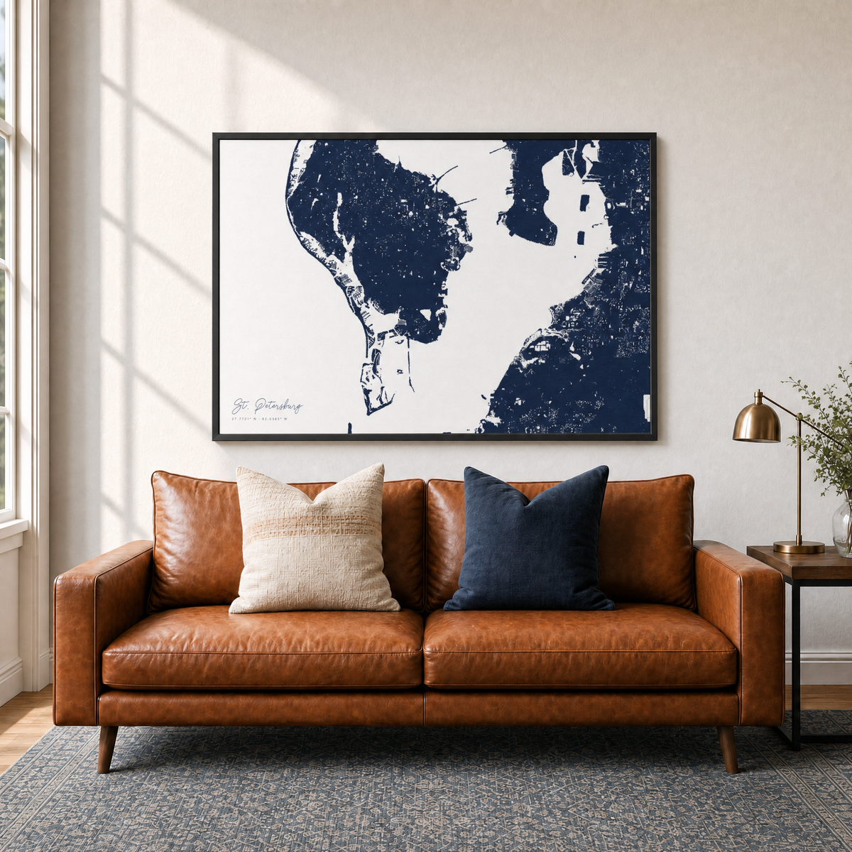 St. Petersburg canvas map — two-pillow black-frame sofa interior