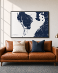 St. Petersburg canvas map — two-pillow black-frame sofa interior