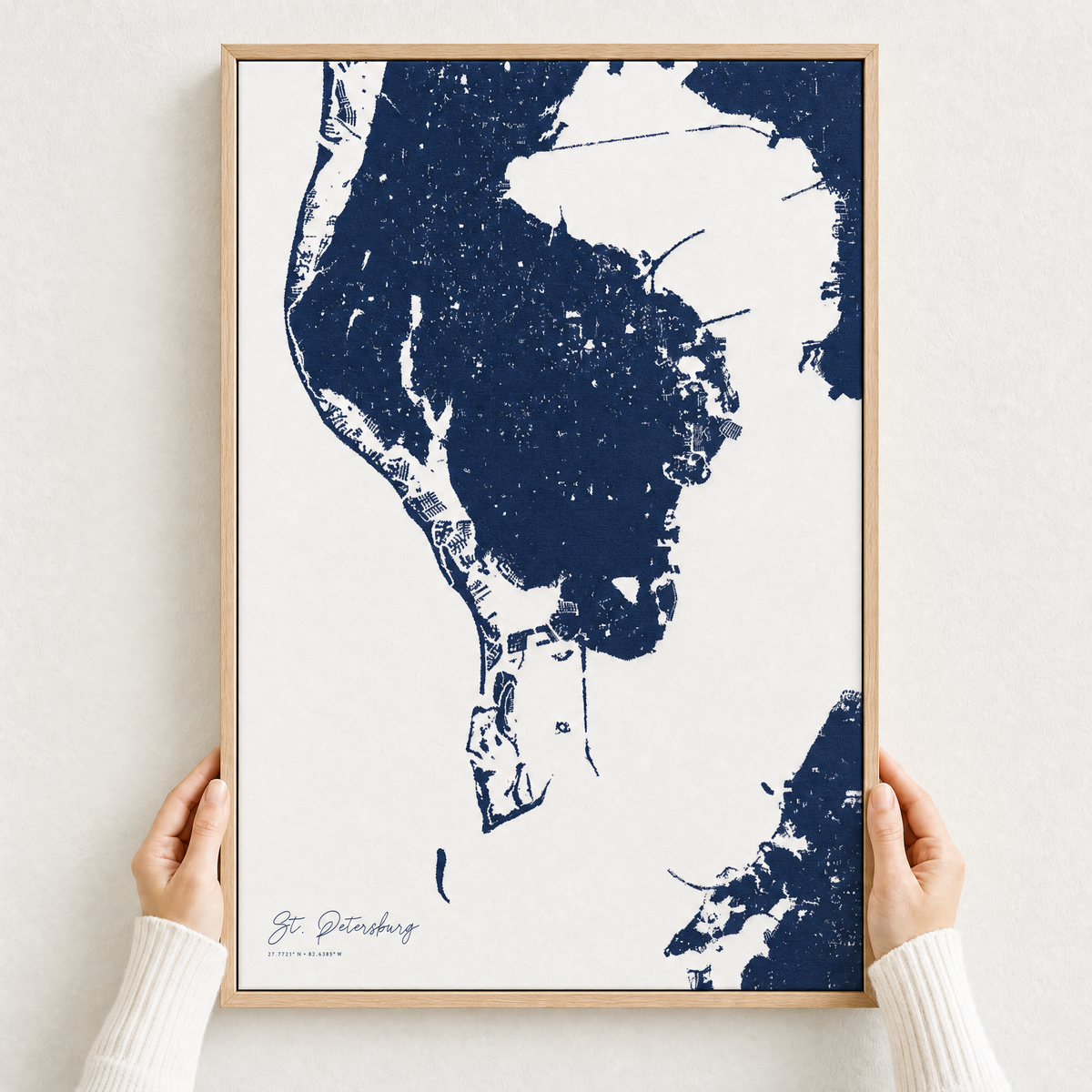 St. Petersburg canvas map — hands holding the canvas in an oak frame