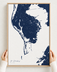 St. Petersburg canvas map — hands holding the canvas in an oak frame