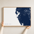 Tampa Bay / Sarasota canvas map — hands holding the canvas in an oak frame