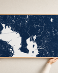 Tampa canvas map — hands holding the canvas in an oak frame