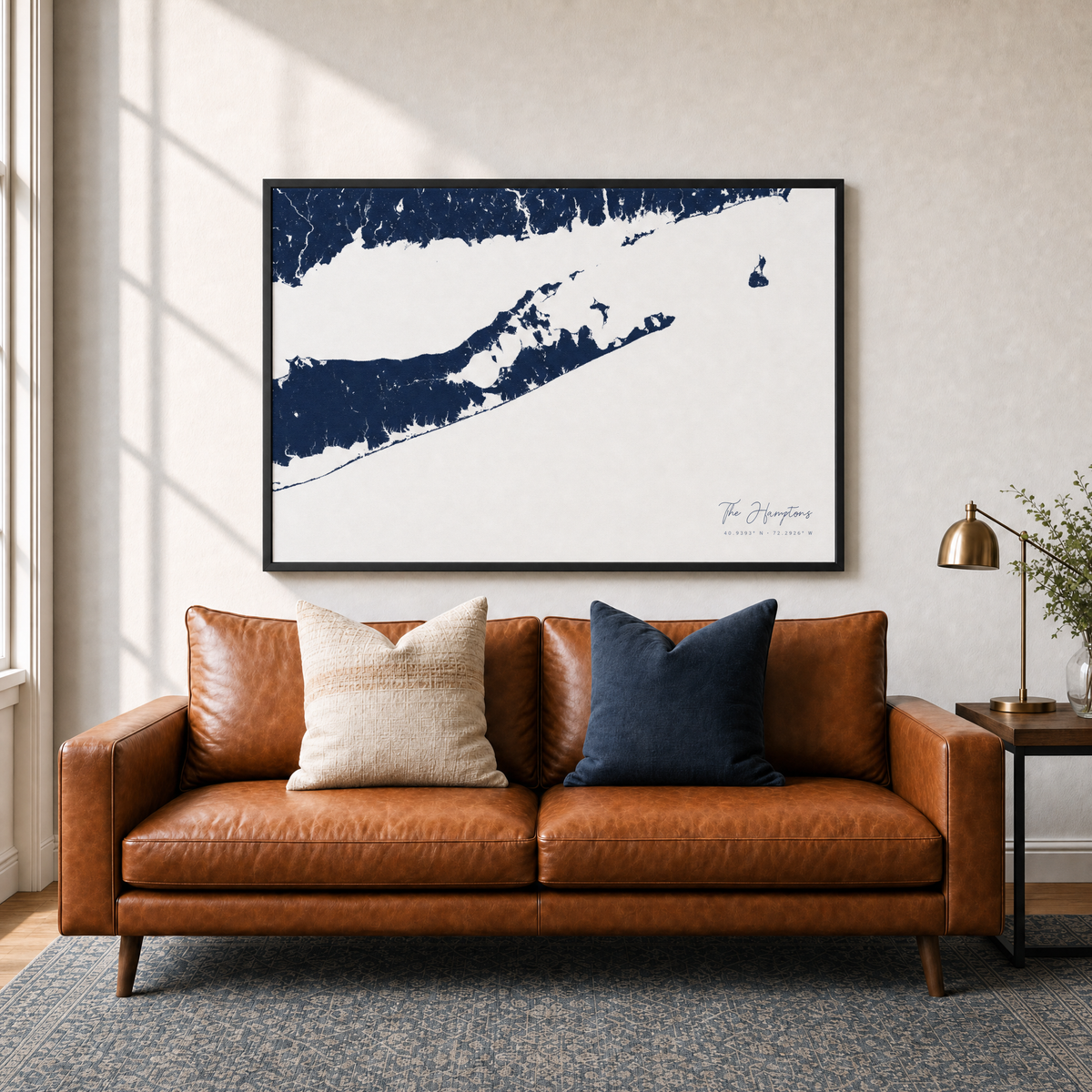 The Hamptons canvas map — two-pillow black-frame sofa interior