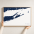 The Hamptons canvas map — hands holding the canvas in an oak frame