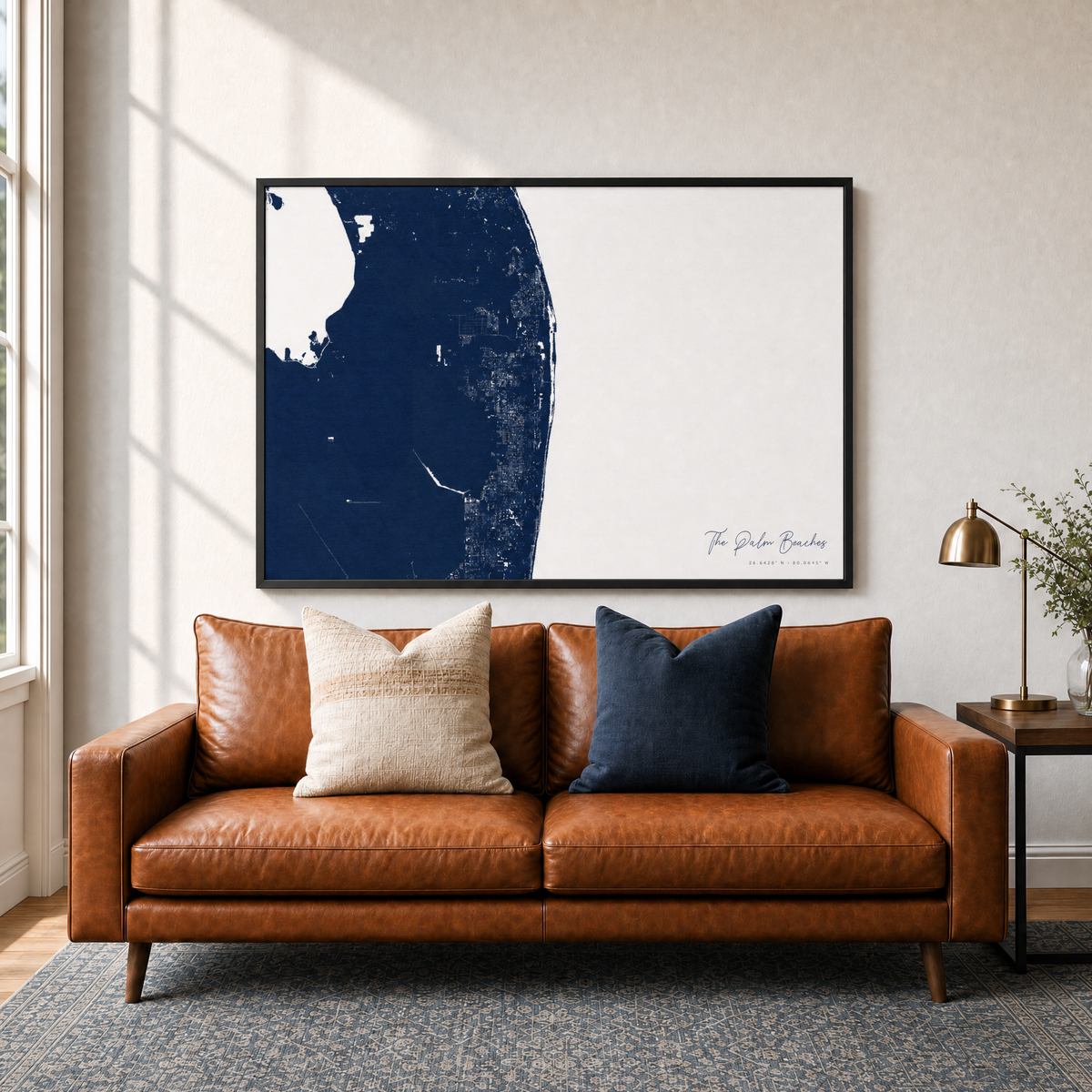 The Palm Beaches canvas map — two-pillow black-frame sofa interior