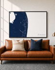 The Palm Beaches canvas map — two-pillow black-frame sofa interior