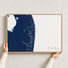 The Palm Beaches canvas map — hands holding the canvas in an oak frame