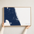 Treasure Coast canvas map — hands holding the canvas in an oak frame