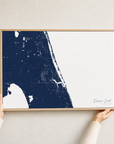 Treasure Coast canvas map — hands holding the canvas in an oak frame