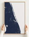 Treasure Coast canvas map — hands holding the canvas in an oak frame