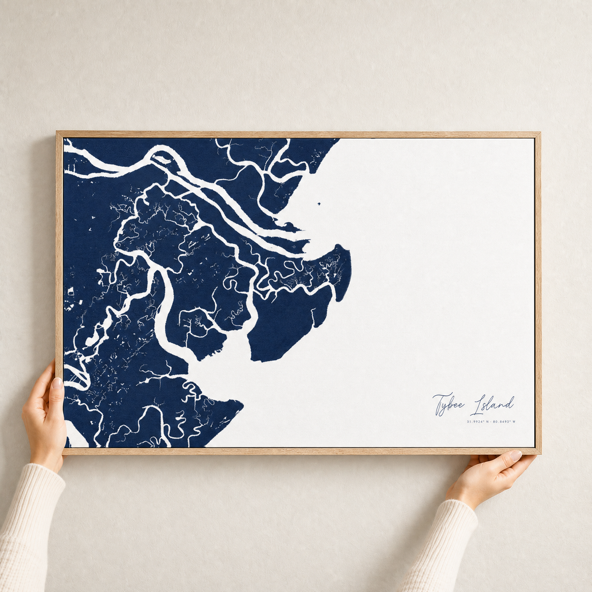 Tybee Island canvas map — hands holding the canvas in an oak frame