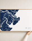 Tybee Island canvas map — hands holding the canvas in an oak frame