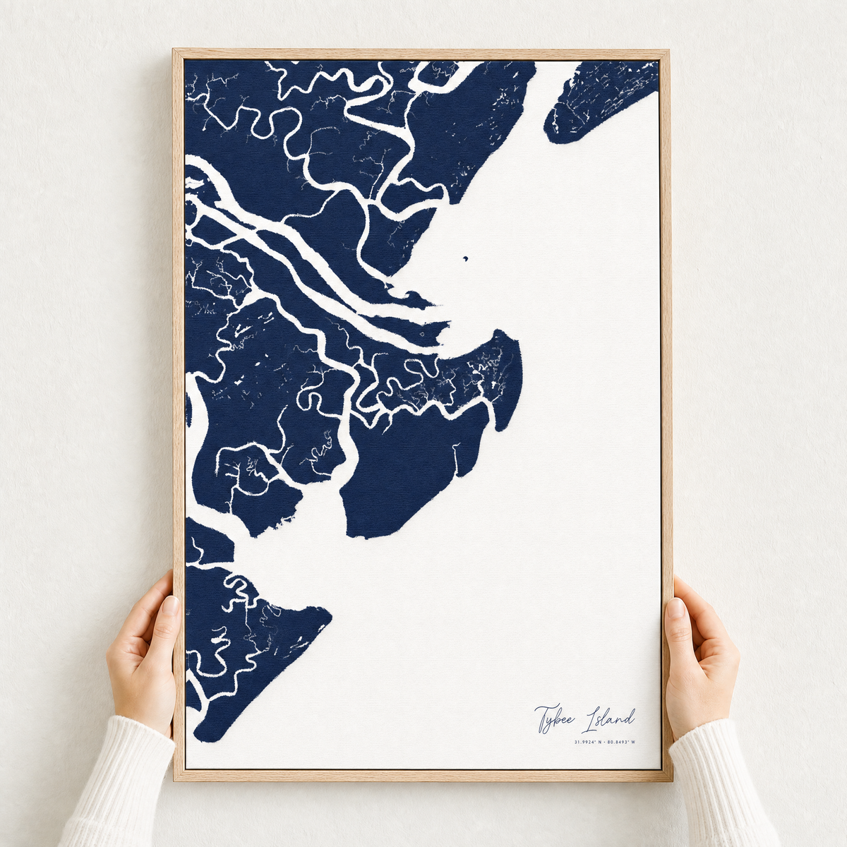 Tybee Island canvas map — hands holding the canvas in an oak frame