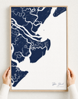 Tybee Island canvas map — hands holding the canvas in an oak frame