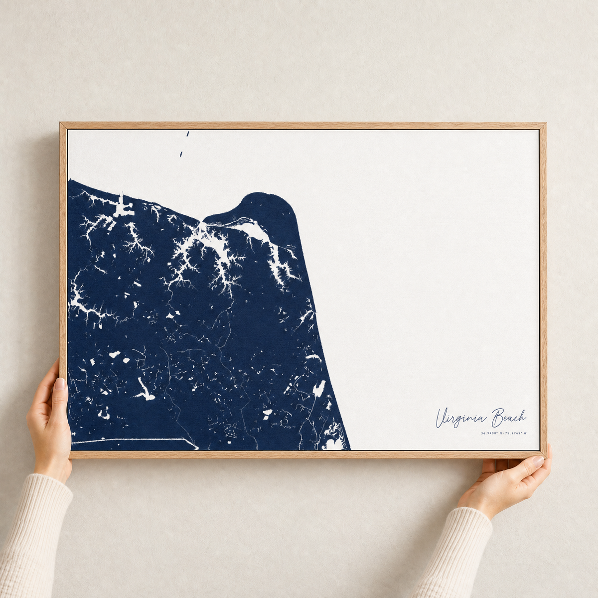 Virginia Beach canvas map — hands holding the canvas in an oak frame