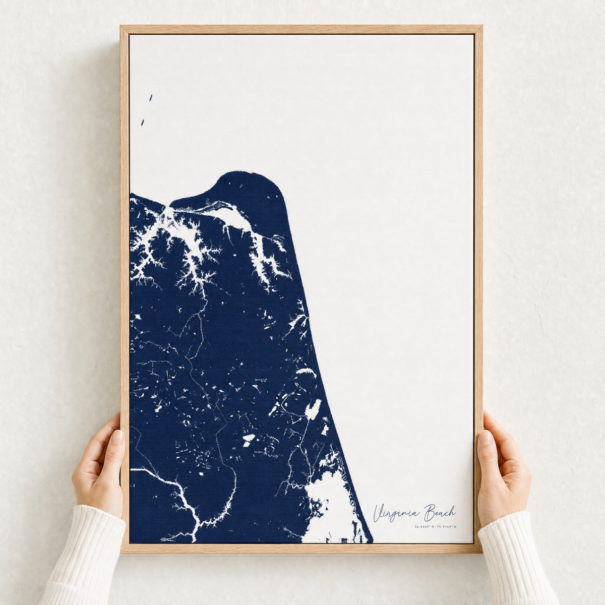 Virginia Beach canvas map — hands holding the canvas in an oak frame