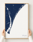 Wilmington canvas map — hands holding the canvas in an oak frame